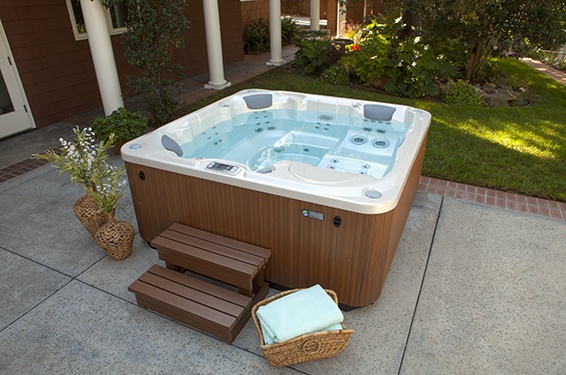 a limelight flair portable hot tub sits on a backyard patio
