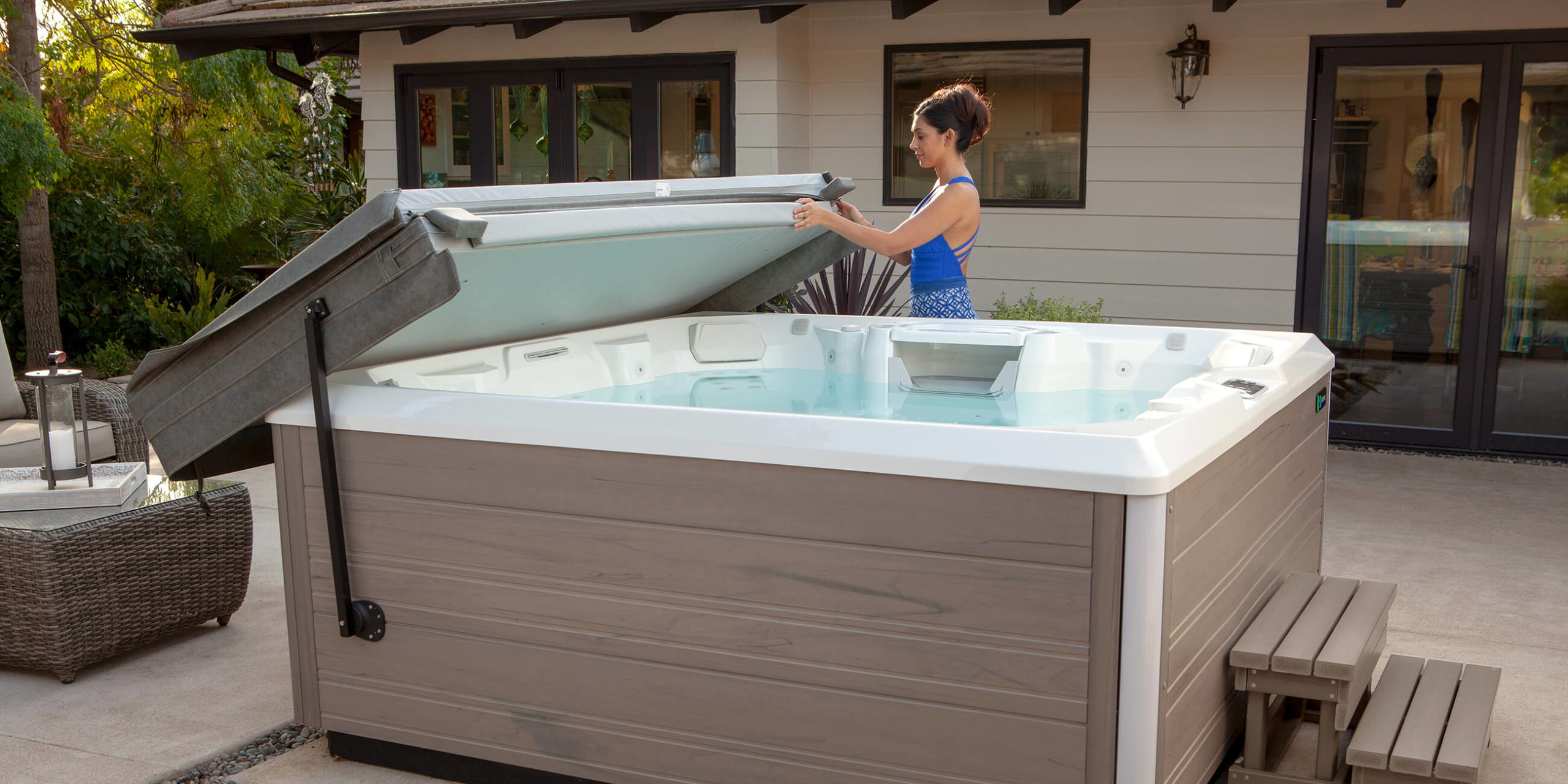 https://www.hotspring.com/wp-content/uploads/2022/03/hot-spring-spas-limelight-collection-page-cspot-lifestyle-cover-lifter-woman-1-scaled.jpg