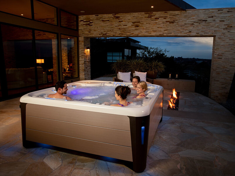 A hot tub enclosure can be a simple roof over your spa or an exterior room that allows you to use your hot tub in even the worst weather.
